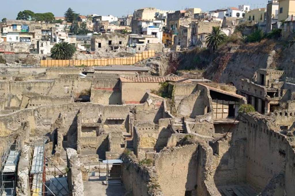 Herculaneum, July 2007. Looking west across site from rear of Ins. Orientalis II, northern end.
The wooden fences across the centre of the photo mark the position of the moving back of the western escarpment, above the Basilica Noniana.
Photo courtesy of Jennifer Stephens. ©jfs2007_HERC-9264.
